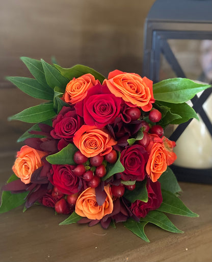 Harvest Dreams product showcasing a bouquet of red and orange roses on a table