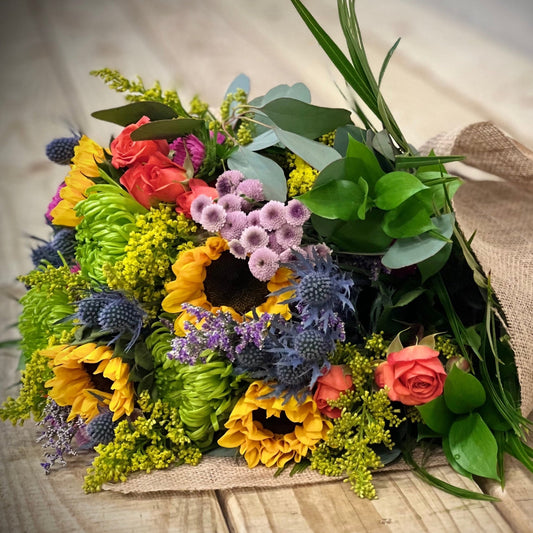 Product 'Spring Fever' displayed as a vibrant bouquet of flowers on a wooden table